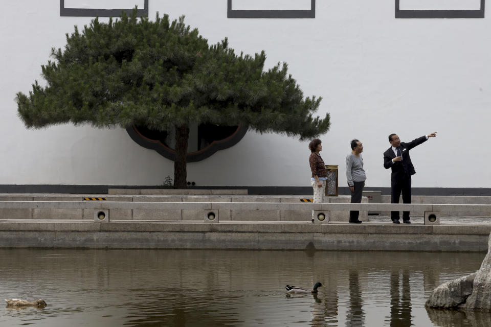 Hotel staff gives directions to visitors as ducks swim in a pond at the Xiangshan hotel designed by Chinese-American architect I.M. Pei and built in 1982 in Beijing, China on Friday, May 17, 2019. Pei, the globe-trotting architect who revived the Louvre museum in Paris with a giant glass pyramid and captured the spirit of rebellion at the multi-shaped Rock and Roll Hall of Fame, has died at age 102, a spokesman confirmed Thursday. (AP Photos/Ng Han Guan)