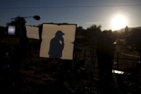 Television crews film at sunrise outside Umpqua Community College in Roseburg, Oregon, United States, October 2, 2015. REUTERS/Lucy Nicholson