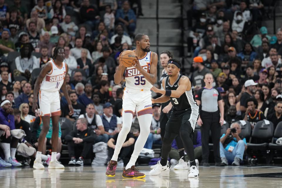 Phoenix Suns forward Kevin Durant (35) faces off against San Antonio Spurs forward Keldon Johnson (3) in the first half at Frost Bank Center in San Antonio on March 23, 2024.