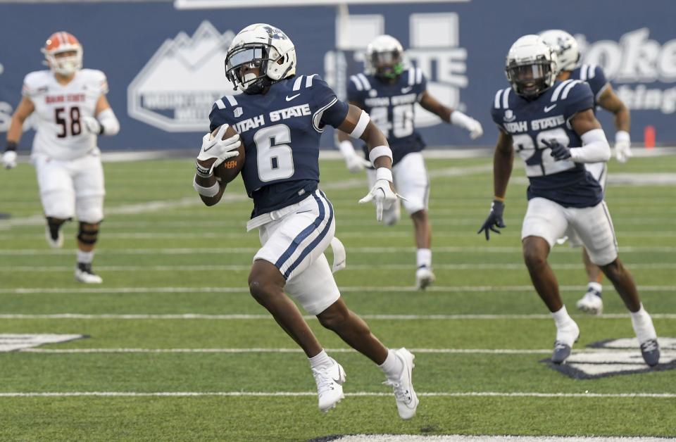 Utah State safety Ike Larsen (6) returns an interception 46 yards for a touchdown against Idaho State during the first half of an NCAA college football game Saturday, Sept. 9, 2023, in Logan, Utah. | Eli Lucero/The Herald Journal via AP