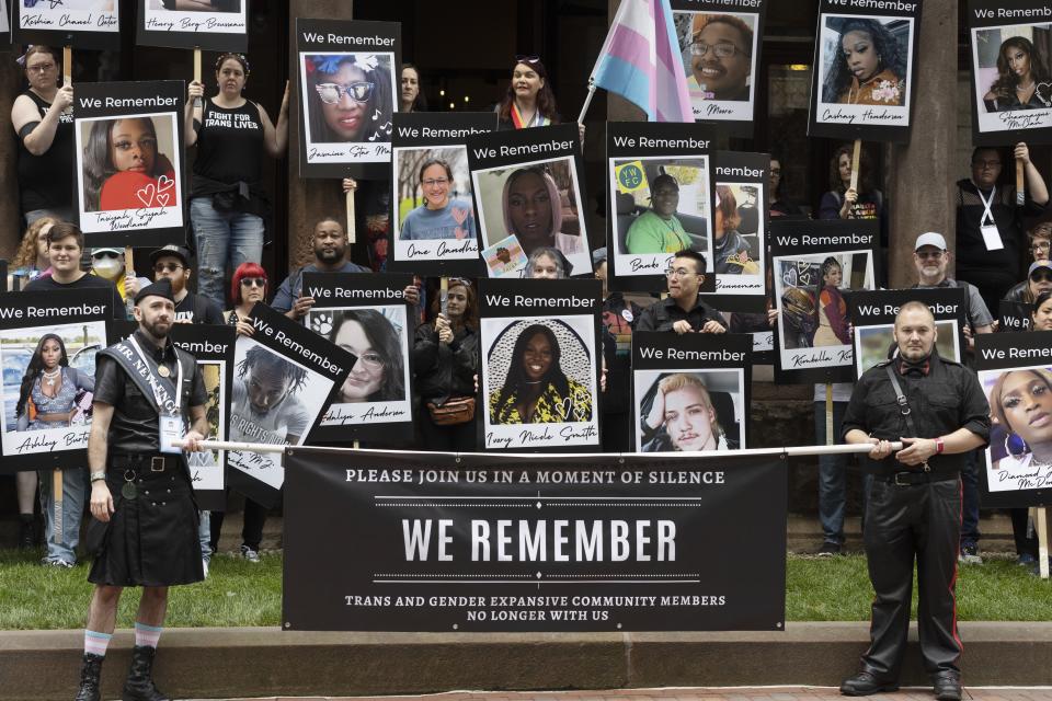 Mason Dunn, lower left, stands with a group memorializing transgender people who died because of bias or hate in the U.S., before marching in the Pride parade, Saturday, June 10, 2023, in Boston. The biggest Pride parade in New England returned after a three-year hiatus, with a fresh focus on social justice and inclusion rather than corporate backing. (AP Photo/Michael Dwyer)