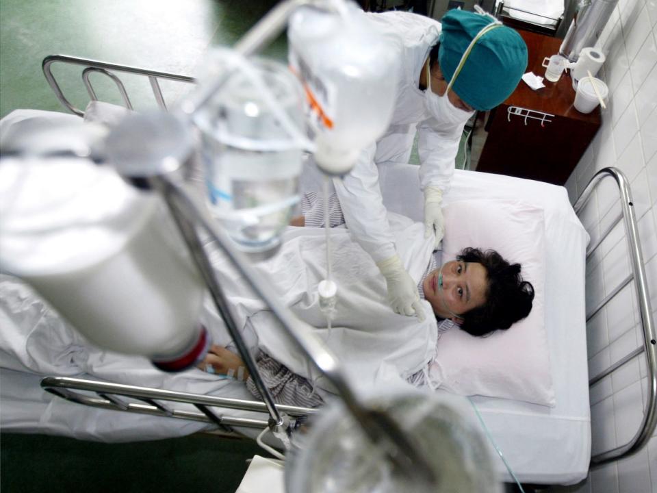 A Chinese nurse tends to a patient recovering from the flu-like Severe Acute Respiratory Syndrome (SARS) at a hospital in Guangzhou, the capital of Guangdong province, April 17, 2003.