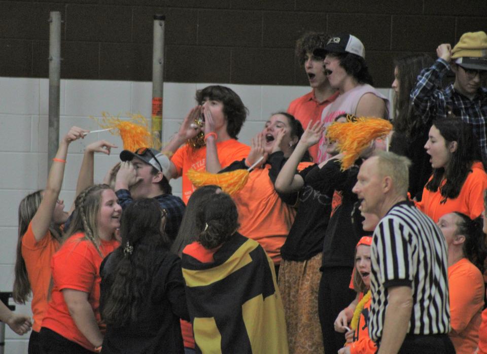 Pellston student supporters cheer on their team during the first half of Tuesday's home game against Onaway. Pellston's students, along with so many others, wore the color orange in support of the Escanaba community following the recent tragedy that occurred late last week.