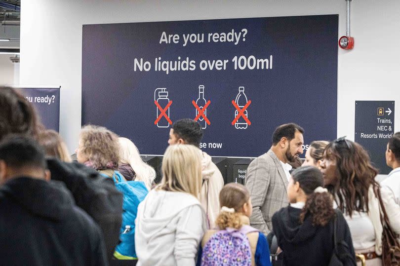 Birmingham Airport No liquids over 100ml sign.

While waiting for a software issue to be resolved with the new scanners (that can scan up to two litres of liquid), passengers arriving at the airport are being reminded to continue to limit liquids in their hand luggage to 100ml.
This will then reduce the need for such long queues for security as have been recently seen.