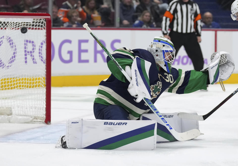Vancouver Canucks goalie Spencer Martin allows a goal to Arizona Coyotes' Jakob Chychrun during the second period of an NHL hockey game in Vancouver, on Saturday, December 3, 2022. THE CANADIAN PRESS/Darryl Dyck/The Canadian Press via AP)