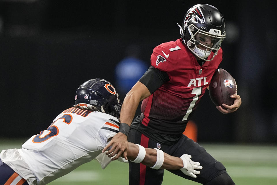 Atlanta Falcons quarterback Marcus Mariota (1) runs out of the pocket against Chicago Bears cornerback Kyler Gordon (6) during the second half of an NFL football game, Sunday, Nov. 20, 2022, in Atlanta. (AP Photo/Brynn Anderson)