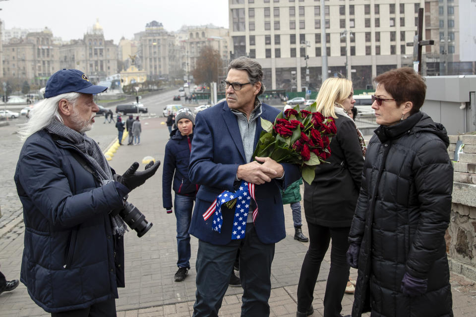 In this Nov. 11, 2018, photo provided by the U.S. Embassy in Kyiv, Energy Secretary Rick Perry talks with Michael Bleyzer, left, and then-U.S. ambassador to Ukraine Marie Yovanovitch as Perry prepares to place flowers at the Heavenly Hundred Memorial in Kyiv, Ukraine. Bleyzer and Alex Cranberg, two political supporters of Perry secured a potentially lucrative oil-and-gas exploration deal from the Ukrainian government soon after Perry proposed one of the men as an adviser to the country’s new president.(U.S. Embassy Kyiv via AP)