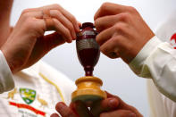 Australia's cricket team captain Steve Smith holds a replica Ashes urn with England's team captain Joe Root during an official event ahead of the Ashes opening test match at the GABBA ground in Brisbane, Australia, November 22, 2017. REUTERS/David Gray