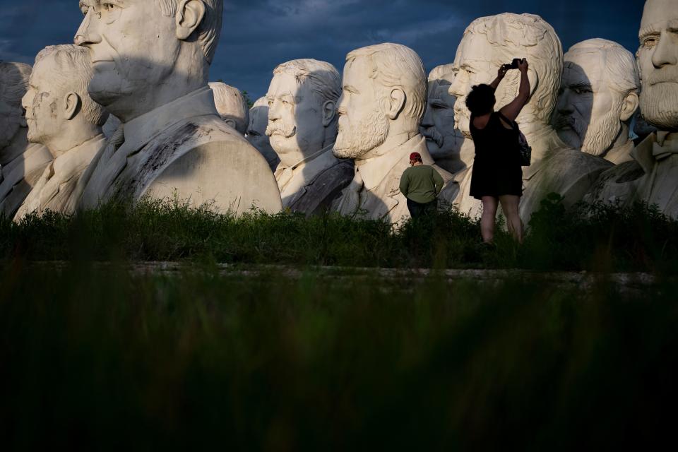 People take photos of decaying busts of former US Presidents during a night photography workshop organized by John Plashal August 25, 2019, in Williamsburg, Virginia. (Photo: Brendan Smialowski/AFP/Getty Images)