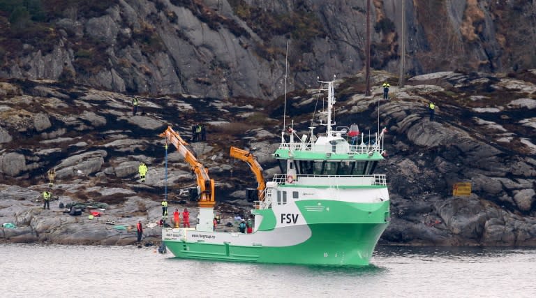 A rescue vessel lifts up parts of the helicopter that crashed off Bergen with 13 people on board, on April 29, 2016