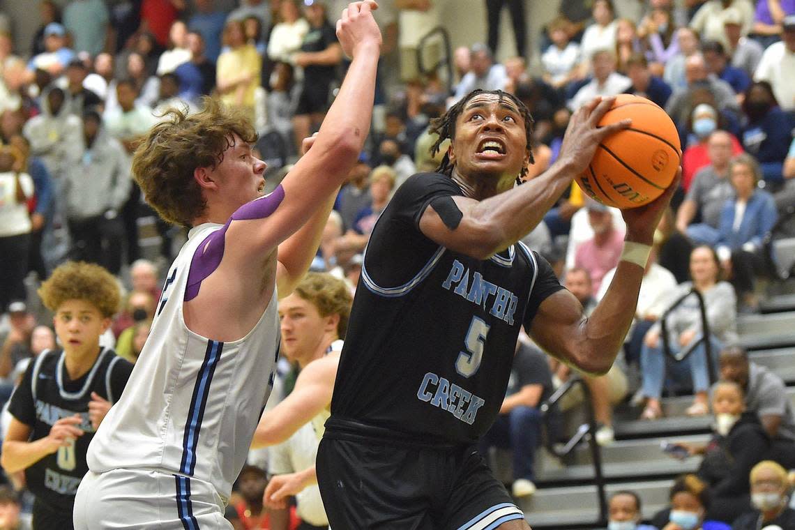 Panther Creek’s Tyler Thompson (5) looks to shoot against Cleveland’s Dylan Smith (25) during the second half. The Panther Creek Catamounts and the Cleveland Rams met in the NCHSAA 4A Boys East Regional Finals in Cary, N.C. on March 5, 2022.
