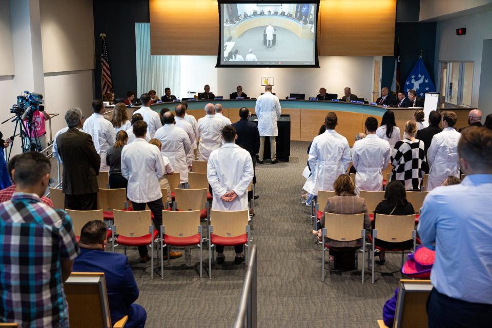 Dr. John Cambron provides public comment on Christus Spohn's termination of its emergency medicine residency program during a City Council meeting on Tuesday, Oct. 17, 2023, in Corpus Christi. Other doctors and community members stand to show support for his comments against the program's closure.
