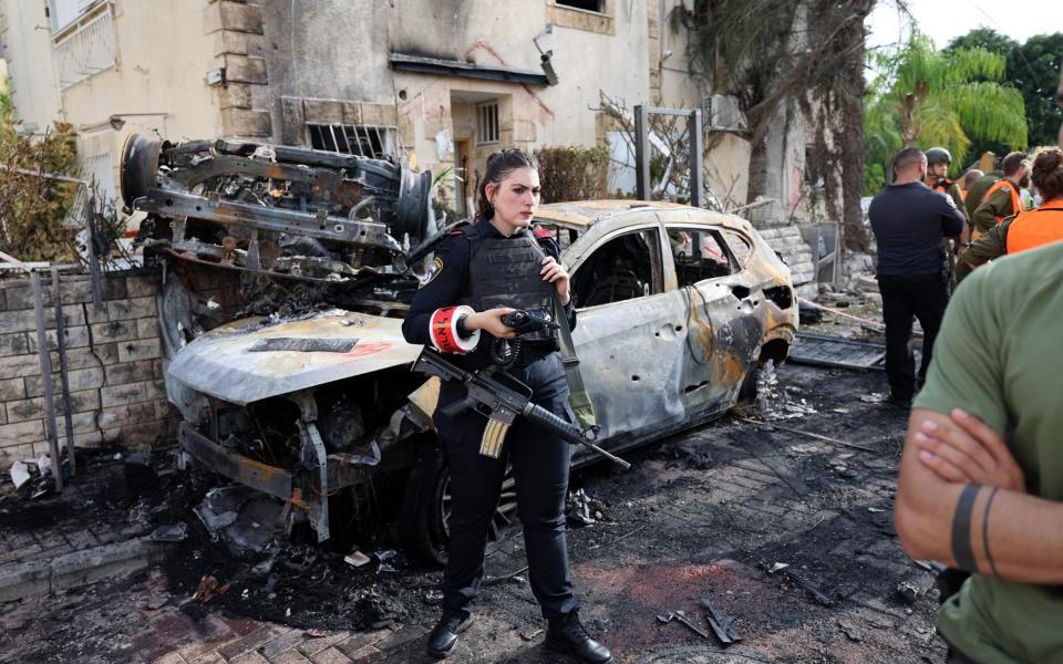 A member of the Israeli security forces stands guard inside a cordoned-off area in Kiryat Bialik