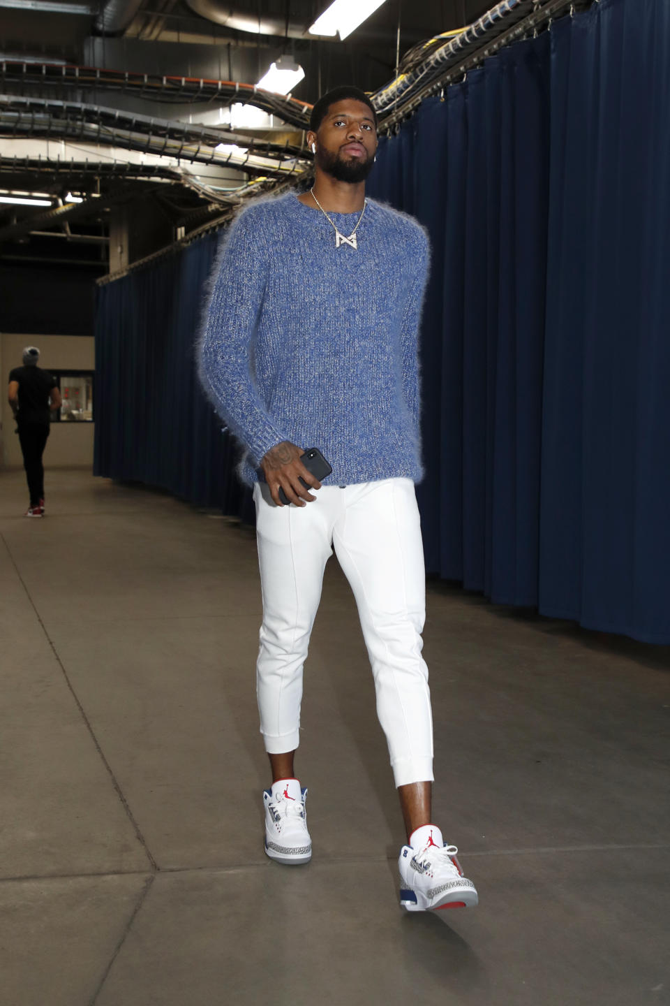 <p>Paul George wears a blue knit sweater and a pair of retro Air Jordan 3s on March 31. </p>