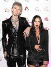 <p>Machine Gun Kelly and Megan Fox arrive chained together by their nails at the launch of the singer's UN/DN LAQR nail polish collab, where Casamigos cocktails were served, on Dec. 4 in West Hollywood. </p>