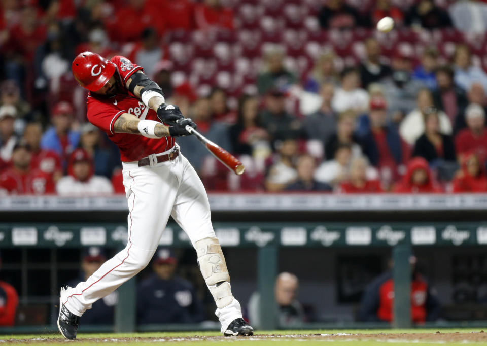 Cincinnati Reds Nick Castellanos hits a solo home run against Washington Nationals pitcher Alberto Baldonado during the sixth inning of a baseball game in Cincinnati, Friday, Sept. 24, 2021. (AP Photo/Paul Vernon)