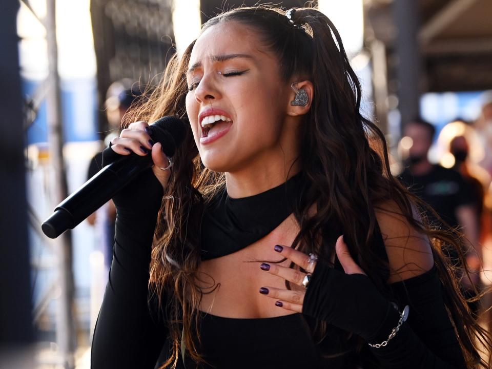 Olivia Rodrigo singing into a microphone in September 2021.
