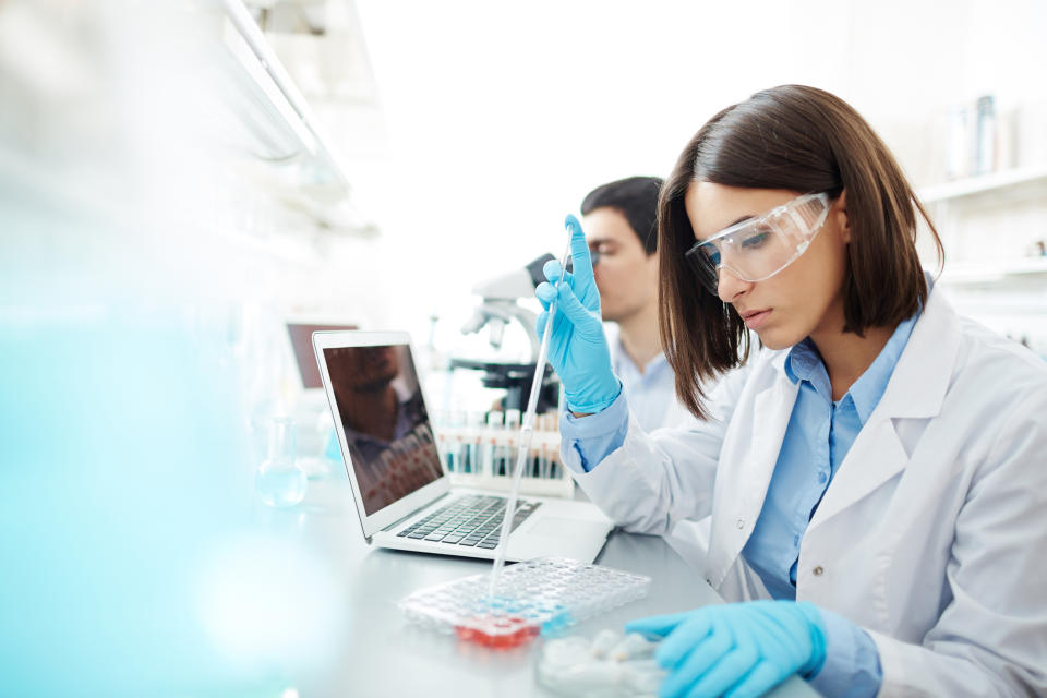 A scientist using a pipette.