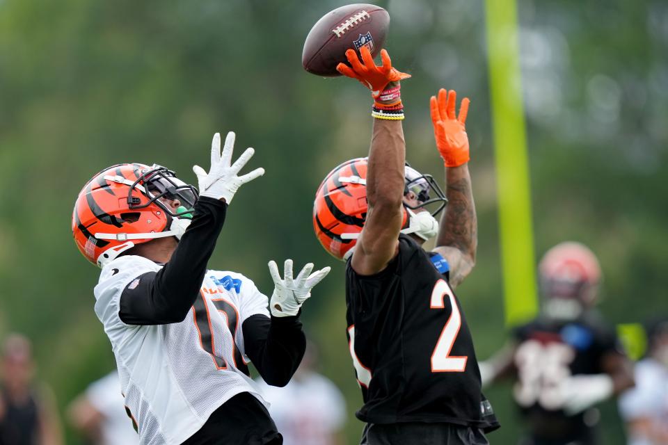 Cincinnati Bengals cornerback DJ Turner II (20) breaks up a pass intended for Cincinnati Bengals wide receiver Shedrick Jackson (12) during training camp practice at the practice fields beside Paycor Stadium.