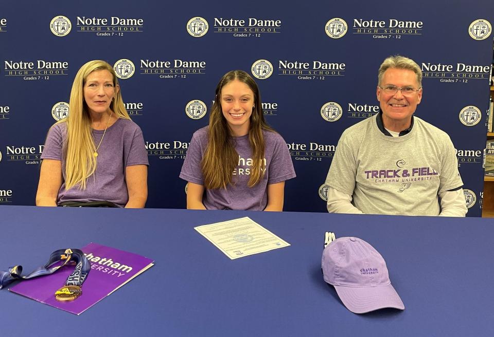 Elmira Notre Dame senior Piper Young signed to compete in track and cross country  at Chatham University on June 6, 2023. Pictured with her are her parents, Vicki and Jerry.