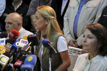 Lilian Tintori (C), wife of jailed Venezuelan opposition leader Leopoldo Lopez, speaks next to Jesus Torrealba (L), secretary of the Venezuelan coalition of opposition parties (MUD) and Mitzy de Ledezma, wife of arrested Caracas metropolitan mayor Antonio Ledezma, during a news conference in Caracas June 3, 2015. REUTERS/Marco Bello -