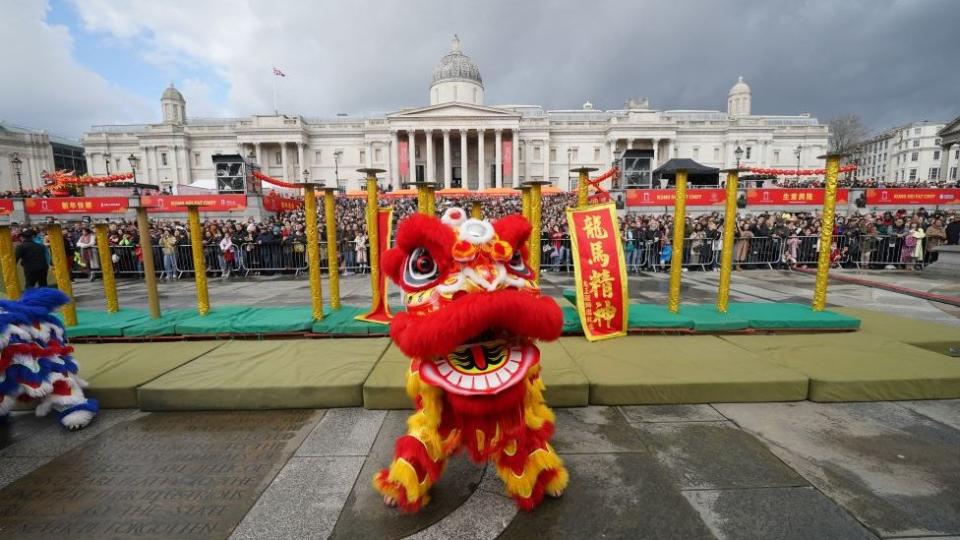 Huge crowds gather in Trafalgar square where traditional chinese celebratory performances are taking place.