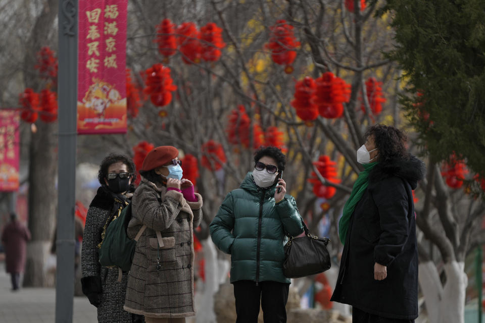 Women wearing face masks visit a public park decorated with Lunar New Year decorations in Beijing, Thursday, Jan. 19, 2023. China on Thursday accused "some Western media" of bias, smears and political manipulation in their coverage of China's abrupt ending of its strict "zero-COVID" policy, as it issued a vigorous defense of actions taken to prepare for the change of strategy. (AP Photo/Andy Wong)