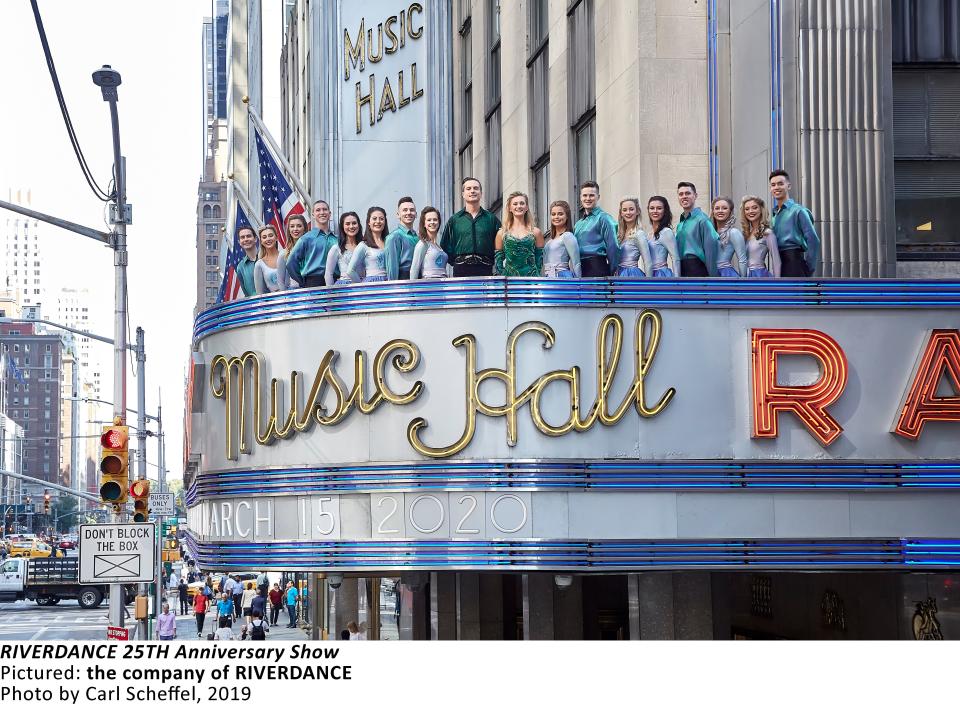 The cast of "Riverdance" pose on the marquee of Radio City Music Hall.