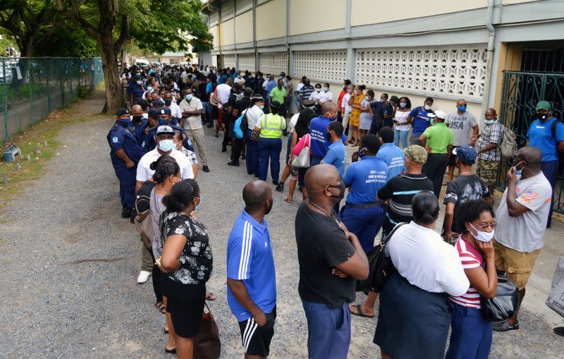 Voters queue at a polling station to cast their ballots during the presidential and parliamentary elections in Victoria