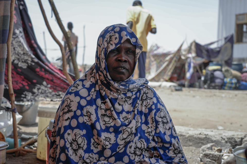 South Sudanese Ehlam Saad, 42, sits at a transit site in Renk, South Sudan Wednesday, May 17, 2023. Tens of thousands of South Sudanese are flocking home from neighboring Sudan, which erupted in violence last month. (AP Photo/Sam Mednick)