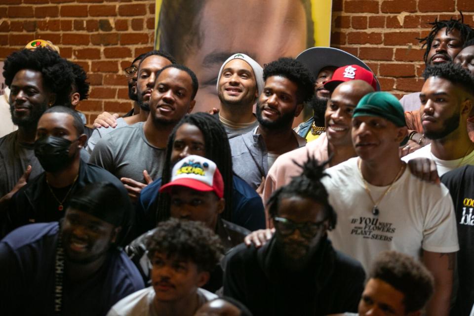 Bobby Brown, back row with skull cap, takes a portrait with other Black men.