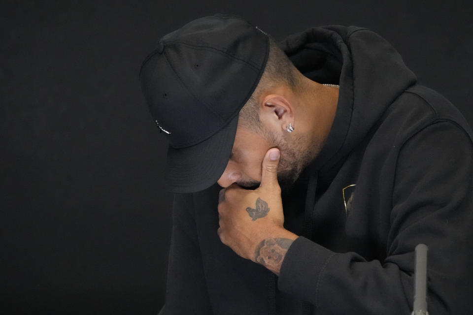 Australia's Nick Kyrgios reacts as he announces his withdrawal from the Australian Open with a knee injury at a press conference in Melbourne, Australia, Monday, Jan. 16, 2023. (AP Photo/Mark Baker)