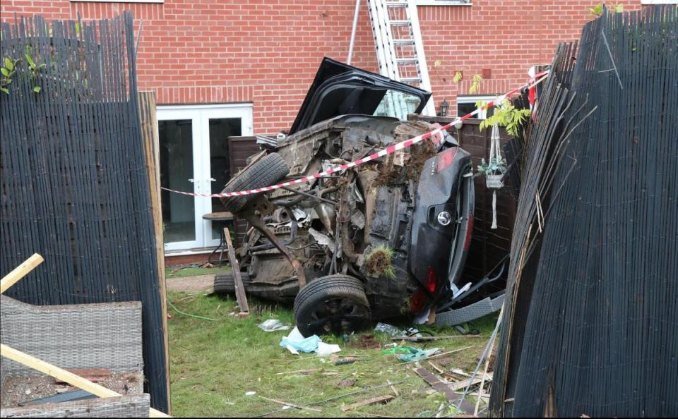 The car came to a stop on its side in a residential garden (Warwickshire Police)
