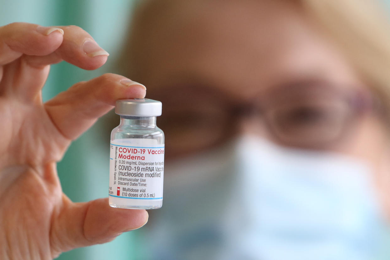 Nurse Lisa Kieh holds a vial of the Moderna Covid-19 vaccine at a vaccination centre at Ffwrnes Theatre in Llanelli, South Wales, on April 9, 2021. - Britain on April 7 began rolling out its third coronavirus vaccine, from US company Moderna, as questions mounted over jabs from the country's main supplier, AstraZeneca. (Photo by Geoff Caddick / AFP) (Photo by GEOFF CADDICK/AFP via Getty Images)