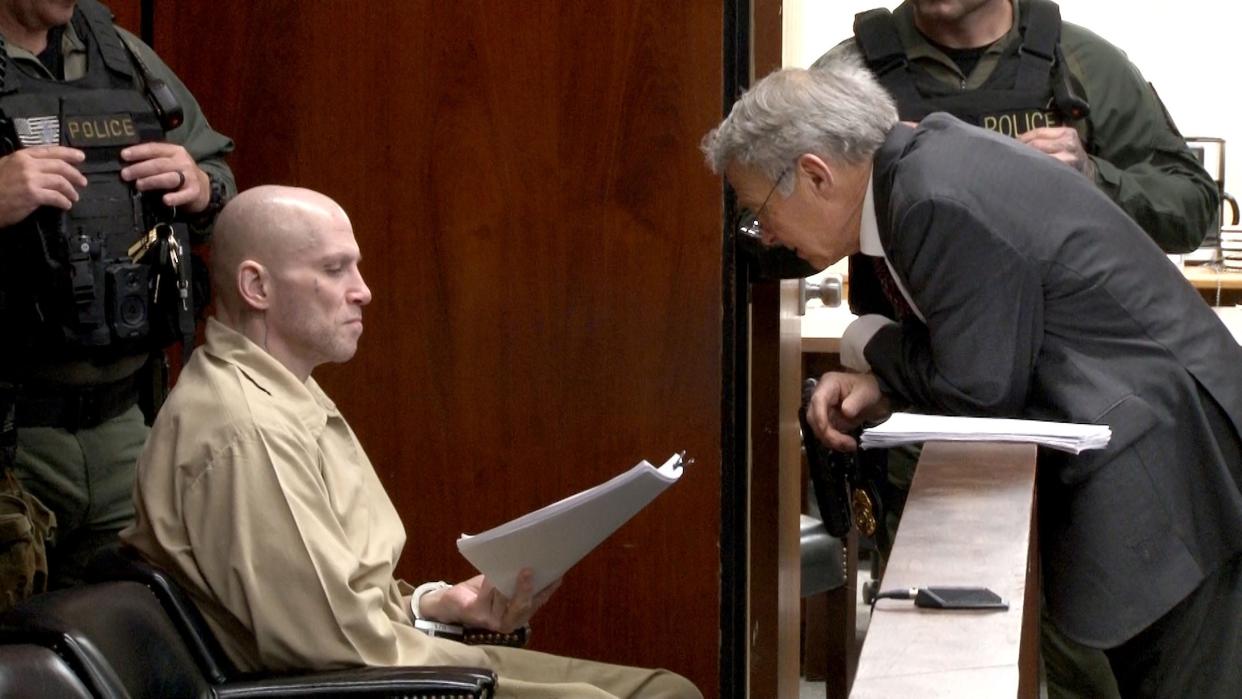 Angelo Grenci reads papers handed to hims by his attorney George Somers before his sentencing for aggravated manslaughter in the 2020 fatal stabbing in Berkeley Township of Carlton Williams. The sentencing was before Superior Court Judge Kimarie Rahill at the Ocean County Courthouse in Toms River Friday, April 19, 2024.