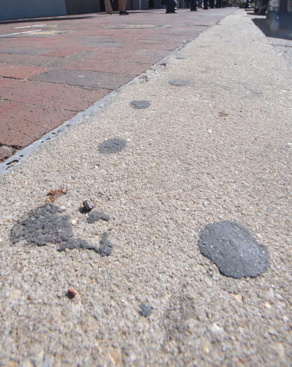 Gum and other debris on the sidewalk along Palafox Place in downtown Pensacola on Tuesday, Jan. 28, 2020.