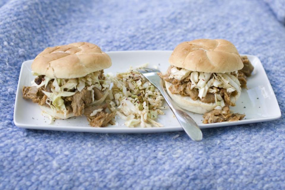 This July 15, 2013 photo shows a North Carolina-style pulled pork sandwich with North Carolina barbecue sauce and coleslaw. (AP Photo/Matthew Mead)