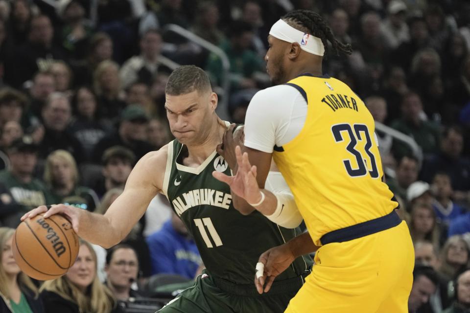 Milwaukee Bucks' Brook Lopez tries to get by Indiana Pacers' Myles Turner during the first half of Game 1 of the NBA playoff basketball game Sunday, April 21, 2024, in Milwaukee. (AP Photo/Morry Gash)