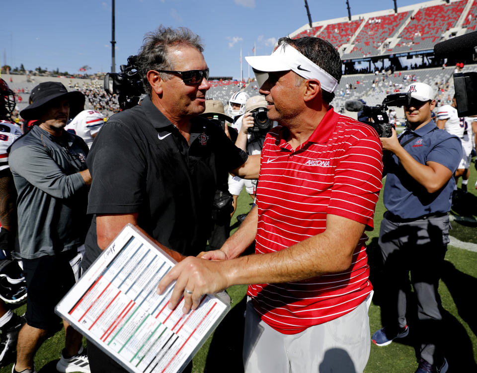 San Diego State coach Brady Hoke and Arizona coach Jedd Fisch meet after an NCAA college football game Saturday, Sept. 3, 2022 in San Diego. (K.C. Alfred/The San Diego Union-Tribune via AP)