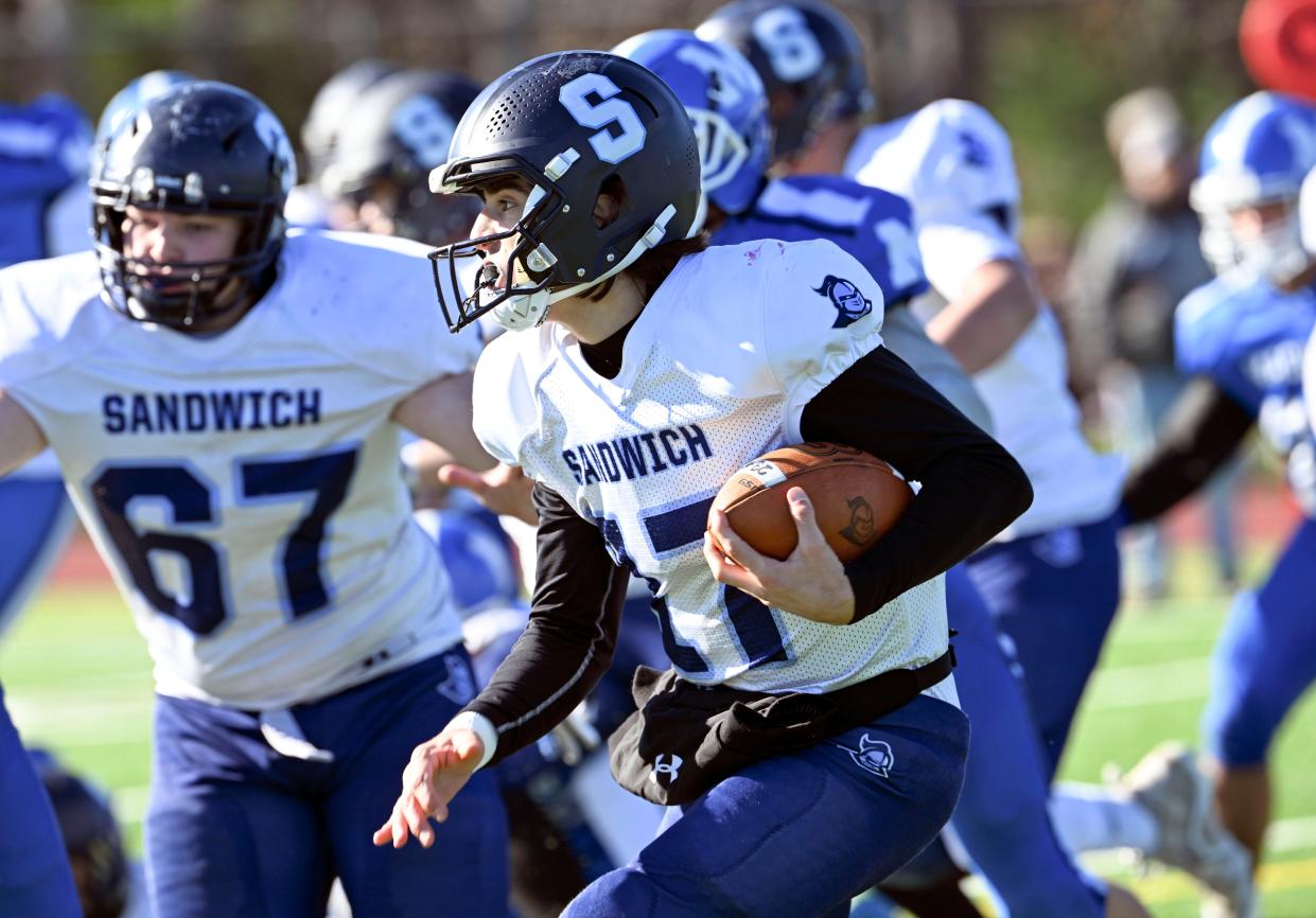 Sandwich quarterback Adam Ferreira follows his blockers against Mashpee.