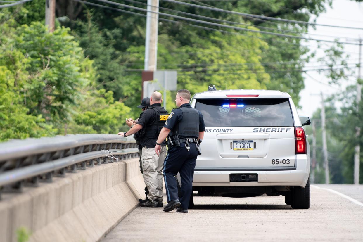 Law enforcement agencies stage along Old Dublin Pike in Maryland during a manhunt on June 26, 2023.