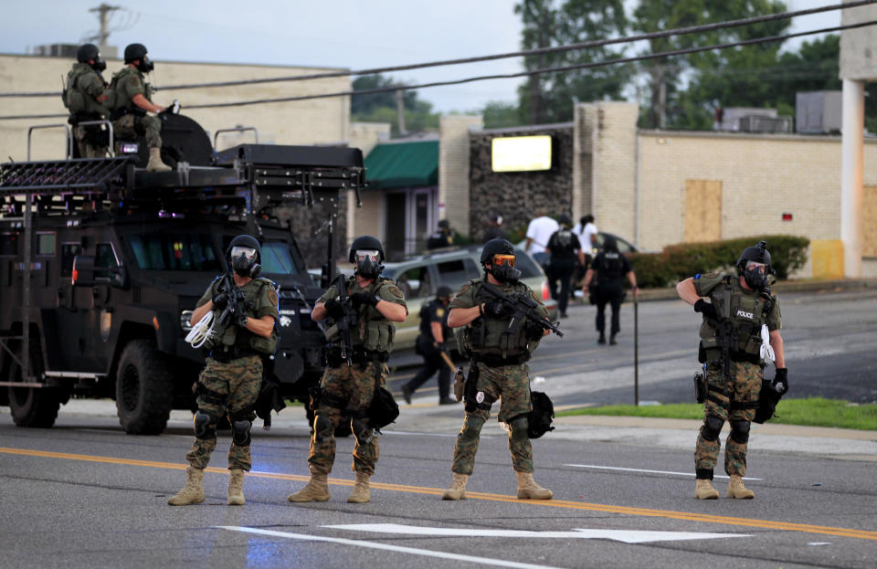 Police wearing riot gear try to disperse a crowd on&nbsp;Aug. 11, 2014, in Ferguson, Missouri. That night, officers&nbsp;used tear gas and rubber bullets to try to disperse a large crowd that had gathered at the site of a burned-out convenience store.