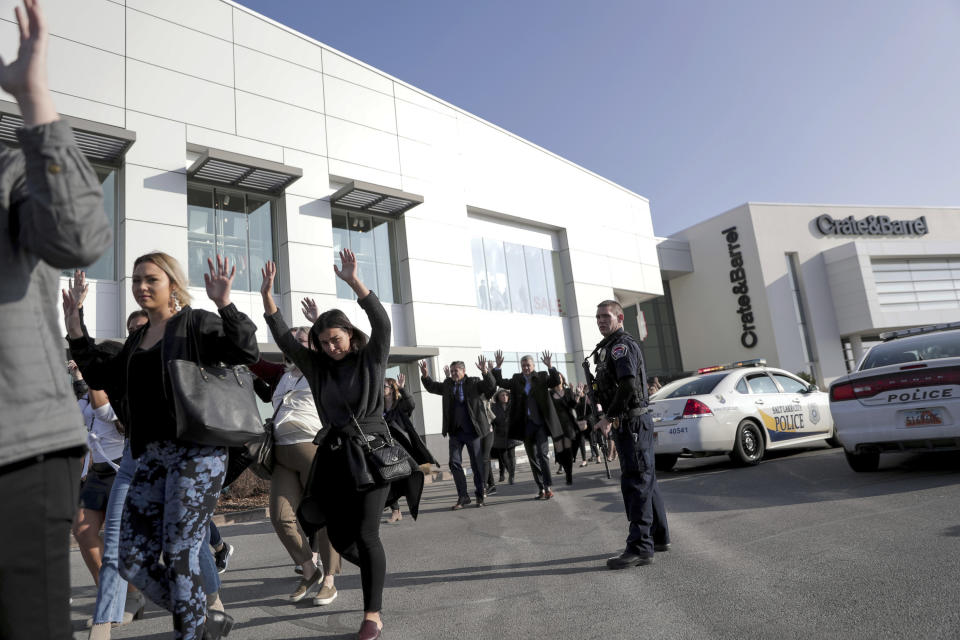 People evacuate after a reported shooting at Fashion Place Mall in Murray, Utah on Sunday, Jan. 13, 2019. (Spenser Heaps/The Deseret News via AP)