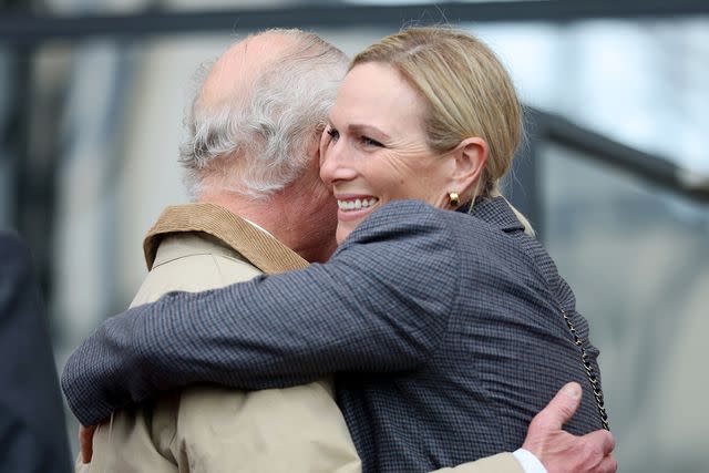 <p>Chris Jackson/Getty Images</p> King Charles and his niece Zara Tindall embraced at the equestrian event