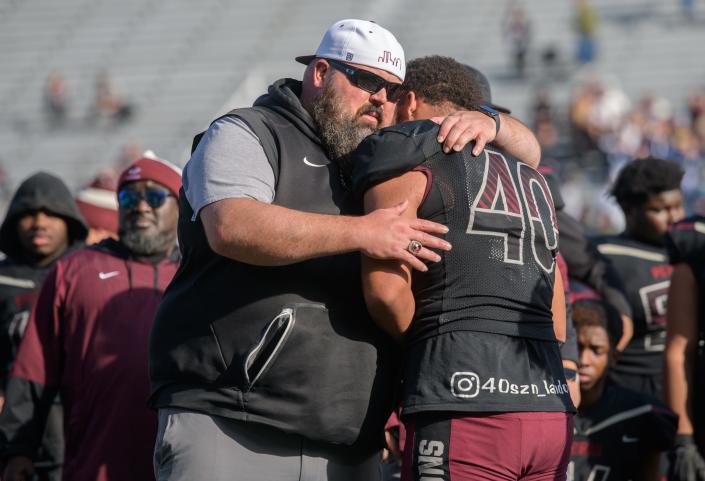 Peoria High head coach Tim Thornton consoles senior lineman Landon Newby-Holesome after the Lions' 45-44 loss to Nazareth Academy in the Class 5A football state title game Saturday, Nov. 26, 2022 in Champaign.