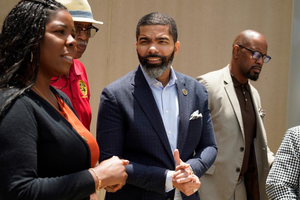 City of Jackson, Miss., Communications Director Melissa Faith Payne, left, tells reporters that Mayor Chokwe Antar Lumumba, center, would not be answering any questions following a status hearing called by United States District Court Judge Henry Wingate regarding recent comments the mayor made about the city's water system on Wednesday at the Thad Cochran United States Courthouse in Jackson.