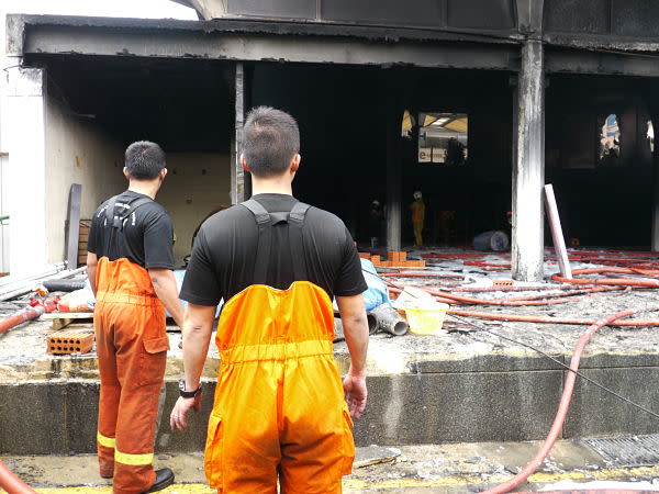 Firefighters looking on at the scene. (Yahoo! photo/ Deborah Choo)