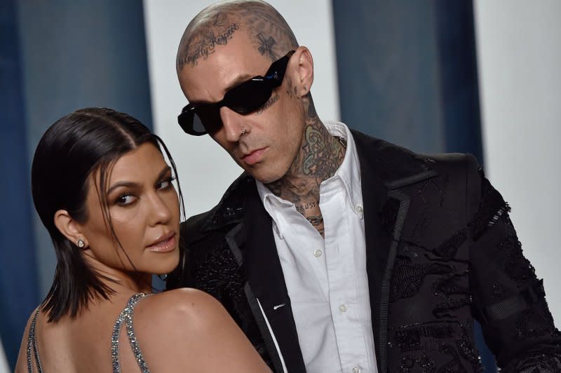 Kourtney Kardashian (L) and Travis Barker arrive for the Vanity Fair Oscar Party at the Wallis Annenberg Center for the Performing Arts in Beverly Hills, Calif., in 2022. File Photo by Chris Chew/UPI