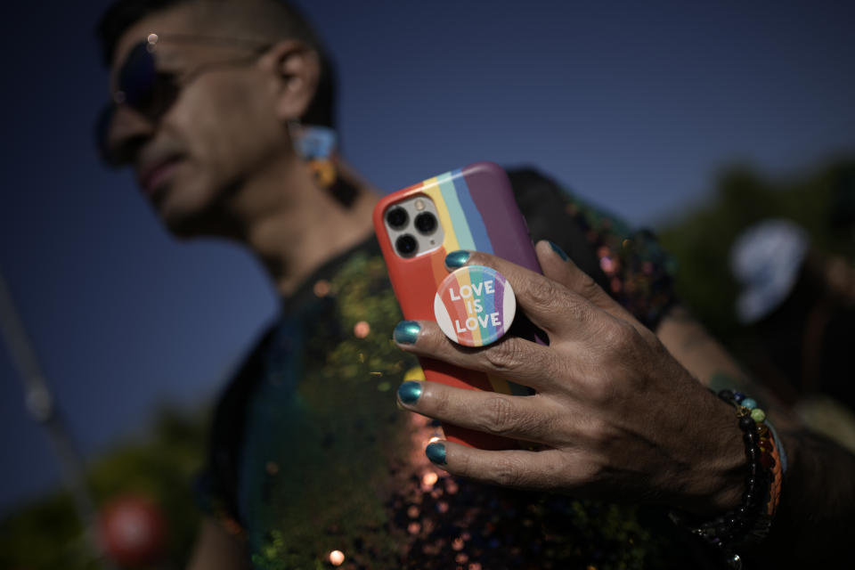 A person shows his phone in the annual Pride parade in Jerusalem, Thursday, May 30, 2024.(AP Photo/Leo Correa)