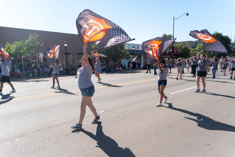 The Guymon High School Marching Band is led down Main Street by their color guard at the 104th annual Wheatheart of the Nation Parade Saturday in Perryton.